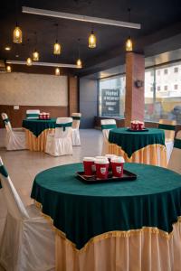 een eetkamer met groene en witte tafels en stoelen bij Hotel Woodlark !! Affordable luxury stay in Chandigarh Tricity ! Tourist Choice in Chandīgarh +14 foto's