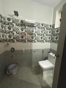 a bathroom with a toilet and a sink at Palukuri's Grand in Vizianagram City