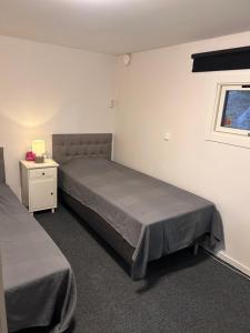 a bedroom with two beds and a window at Mini Hus in Märsta +2 photos