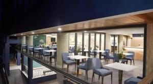 un ristorante con tavoli e sedie su un balcone di Phattrasom Villa a Petchaburi