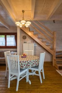 a dining room with a table and chairs and stairs at Znamirówka in Znamirowice