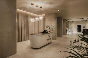 a lobby with a reception desk with a laptop on it at Best View Fortina Luxury Suites in Sliema +25 photos