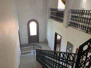 an empty hallway with stairs and a window at Hermosa casa súper equipada in Miramar +1 photo