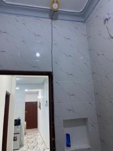 a room with a wall covered in white marble at Casa Bellah Sunrise in Watamu +57 photos