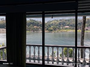 a view of a river from a window at Alexander Homestay in Tuktuk Siadong