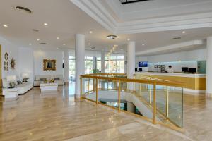 a living room with a staircase in a house at Cala Millor Garden Hotel - Adults Only in Cala Millor