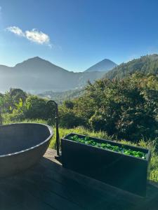 a bath tub sitting on a table with a view at 7 Dreams Glamping #5 in Kubupenlokan +11 photos