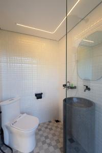a bathroom with a toilet and a glass shower at 7 Dreams Glamping #5 in Kubupenlokan