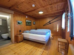 a bedroom with a bed in a wooden room at Chalet Rosablanche, since 1929 - peace, quiet & tradition in Nendaz