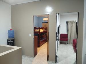 a living room with a door leading to a kitchen at Casa dois quartos 5 pessoas, no centro de Belém in Belém