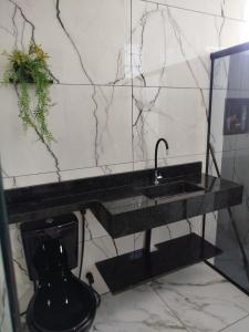 a bathroom with a black sink and a toilet at Casa dois quartos 5 pessoas, no centro de Belém in Belém