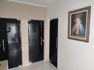 a room with two doors and a painting on the wall at Casa dois quartos 5 pessoas, no centro de Belém in Belém +2 photos