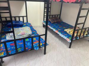 a bedroom with two bunk beds with toys on them at Royal Himalayan Hostel in Ban Phraek Sa