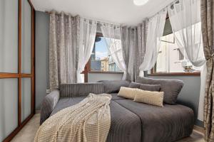 a bedroom with a bed and a window at Dany's Apartments in Varna City +49 photos