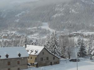 a town covered in snow with houses and trees at les gentianes in La Salle Les Alpes +6 photos
