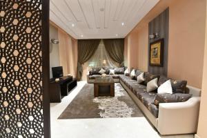 a living room with a couch and a table at Bellington Appart Hôtel in Saïdia