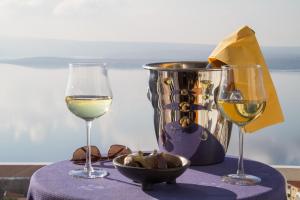 a table with two glasses of wine and a bucket at Holiday Home Marija with Pool & Garden & Amazing Sea View in Dramalj