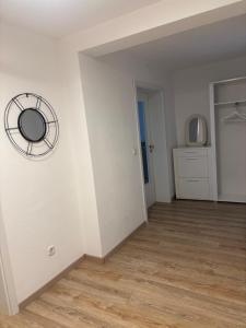 a room with a white wall with a fan on the wall at Ferienwohnung Am Sonnenrain in Albshausen
