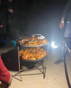 una tavola con tre vassoi di cibo sopra di Gakleen luxury camp ad Aqaba