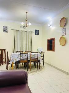 a dining room with a table and chairs at KidotuiVillaHome in Arusha
