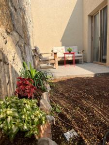 a bench and a table in front of a building at מול ים המלח in Ovnat +3 photos