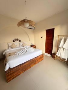 a bedroom with a large bed with white sheets at Pinggan Everest Bali in Gretek