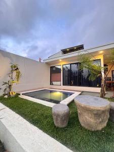 a house with a swimming pool in the yard at Pinggan Everest Bali in Gretek