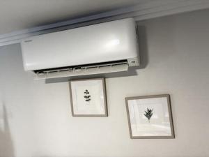 a kitchen with two framed pictures and a firefficiencyfficiencyfficiencyfficiencyfficiencyfficiencyfficiency at Courtyard Pool Studio Private Luxe Retreat in Coal Point