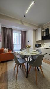 een woonkamer met een tafel en stoelen en een keuken bij Residence Apartment Osh Шикарные апартаменты в самом Элитном районе города Ош in Osh