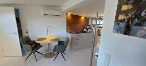 a kitchen with a table and chairs in a room at Gartencharlet in Extertal