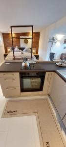 a bedroom with a bed and a desk with a mirror at Gartencharlet in Extertal