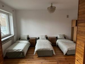 a room with four beds and a window at CityHalo Hostel in Marki