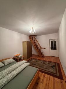 a bedroom with a bed and a staircase in the background at CityHalo Hostel in Marki