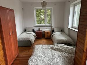 a room with four beds and a window at CityHalo Hostel in Marki