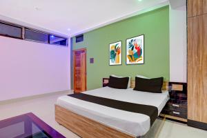 een slaapkamer met een bed met een groene muur bij Hotel O shreyansh in Chupra