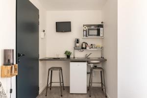 a small kitchen with a sink and a microwave at Studio Chambre St Genest Malifaux in Saint-Genest-Malifaux