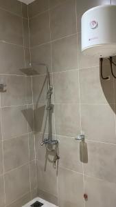 a shower with a light and a toilet in a bathroom at Forever Appartements Cosy luxe in Cotonou