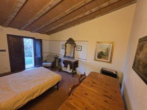 En eller flere senge i et værelse på Agriturismo Collina degli Ulivi