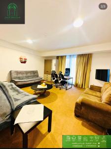 un soggiorno con un divano e un tavolo di Carthage suites hotel a Baghdād