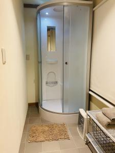 a shower with a glass door in a bathroom at hayama satoyado in Hayama +14 photos