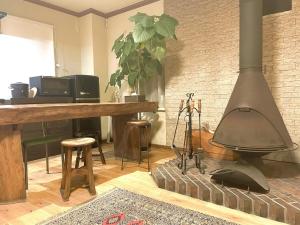 a living room with a brick wall and a stove at hayama satoyado in Hayama