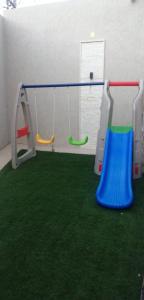 a play room with swings and green carpet at شاليهات ايفا 2 in Taif