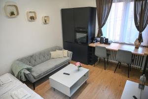a living room with a couch and a table at Cozy Studio Heart in Banská Bystrica