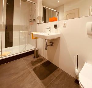 a bathroom with a sink and a shower at Haus am Park in Bad Hersfeld +21 photos