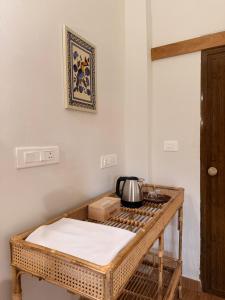 a kitchen with a table with a tea kettle on it at Bhoomi by Ostello in Varkala