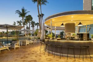 a bar at a resort with tables and chairs at Sheraton Jeddah Hotel in Jeddah