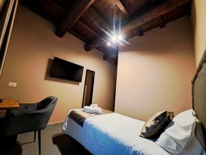 een kleine kamer met een bed en een stoel bij IL MOLINO del SIGNORE in Pergola