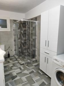 a shower in a bathroom with a checkered floor at My Flowers in Árgos Orestikón