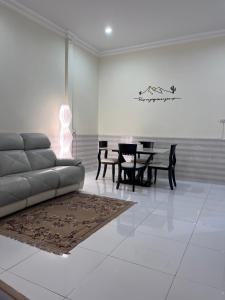 a living room with a couch and a table at Farwa home in Kampong Rusamileh