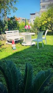 twee stoelen en een tafel en een bank in een tuin bij Arsuz Suit 1 in Hatay +1 foto
